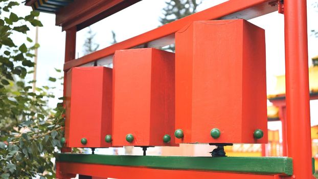 Rotation of the red prayer drums outside the Buddhist temple