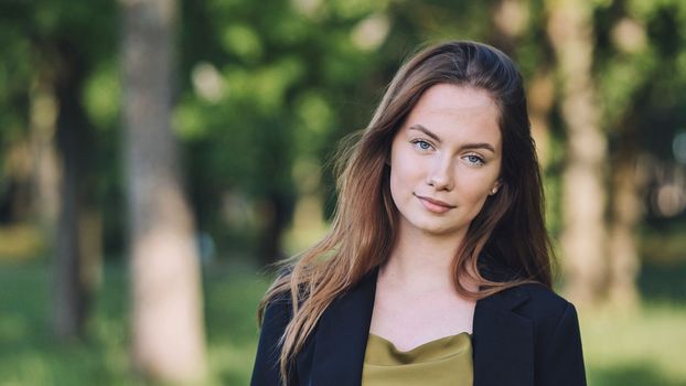 Portrait of a young student in a city park
