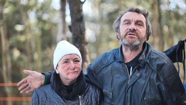 Homeless people are interviewed in the winter in the woods