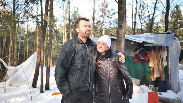 Homeless people are interviewed in the winter in the woods