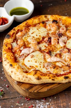 Italian pizza with shrimp and mozzarella on a cutting board