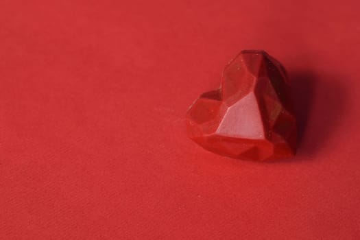 Valentine's background, a delicious red chocolate on a red background.