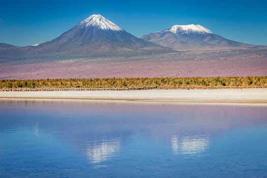 Licancabur and Peaceful reflection lake with dramatic volcanic landscape at Sunset, Atacama Desert, Chile