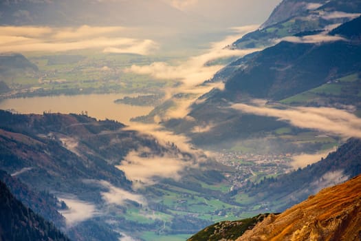 Hohe Tauern mountains and lake from above Grossglockner road at dramatic dawn, Austria