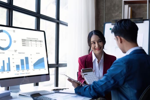 Young Asian business team creative businesspeople coworker in office. Meeting Presentation for tax analysis graph company financial. People Work in Business Office.