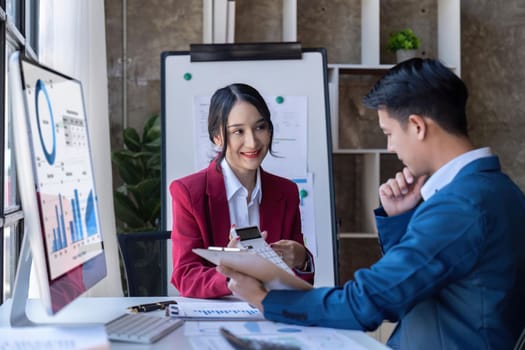 Young Asian business team creative businesspeople coworker in office. Meeting Presentation for tax analysis graph company financial. People Work in Business Office.