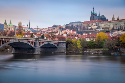 Panoramic view over the cityscape of Prague and Vltava river at dramatic sunset, Czech Republic