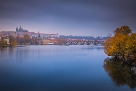 Panoramic view over the cityscape of Prague and Vltava river at dramatic evening, Czech Republic