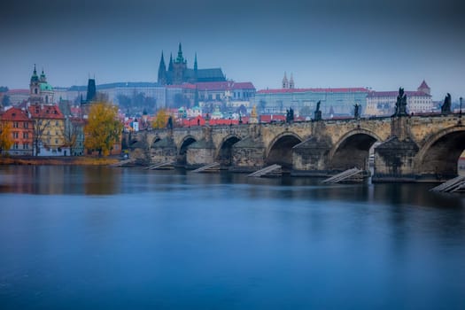 Panoramic view over the cityscape of Prague and Vltava river at dramatic evening, Czech Republic