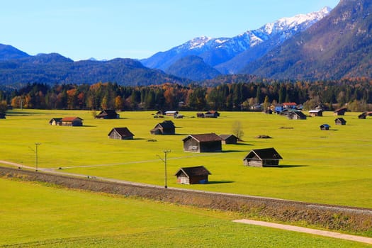 Bavarian alps and rustic farm barns, Garmisch Partenkirchen, Zugspitze massif, Bavaria, Germany