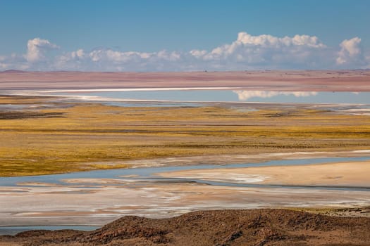 Salt lake reflection and idyllic volcanic landscape at Sunset, Atacama desert, Chile border with Bolivia