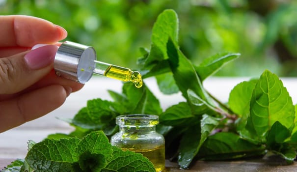The mint extract in a small jar. Selective focus.