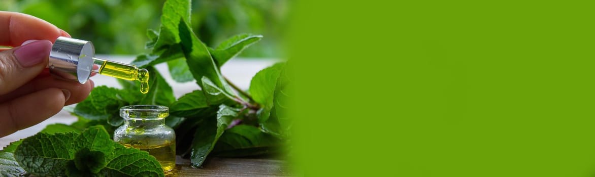 The mint extract in a small jar. Selective focus.