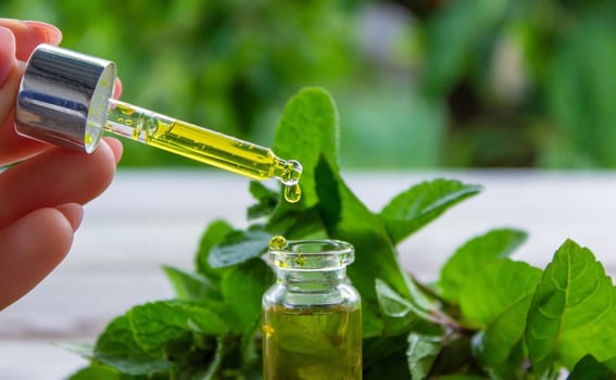 The mint extract in a small jar. Selective focus.