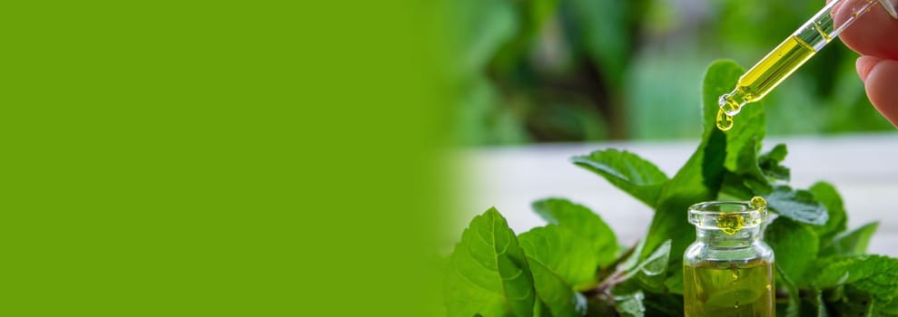 The mint extract in a small jar. Selective focus.