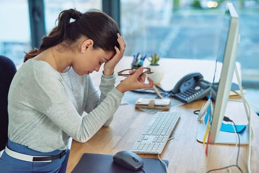 I just need this day to end. a young businesswoman looking stressed out in an office