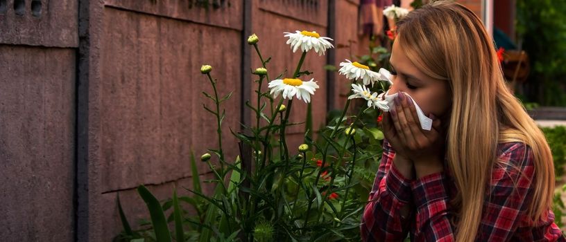 A young woman is allergic to flowers. Selective focus