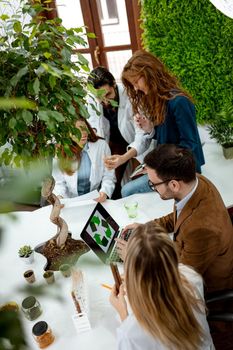 University biologists colleagues taking experiment on sprout and checking the analysis of the sample of plant in the lab tube.       