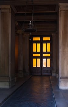 View of illuminated ancient door in Trieste, Italy