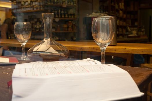 Wine book, glasses and decanter on the table