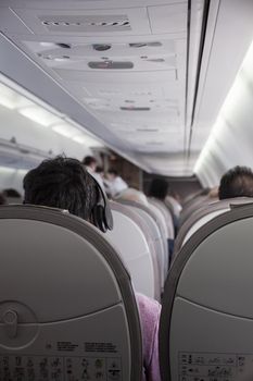 Interior of airplane with passengers on seats