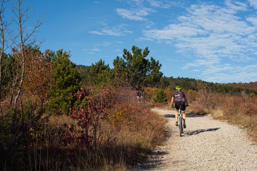 Mountain Bike cyclist riding countryside track, Val Rosandra. Italy