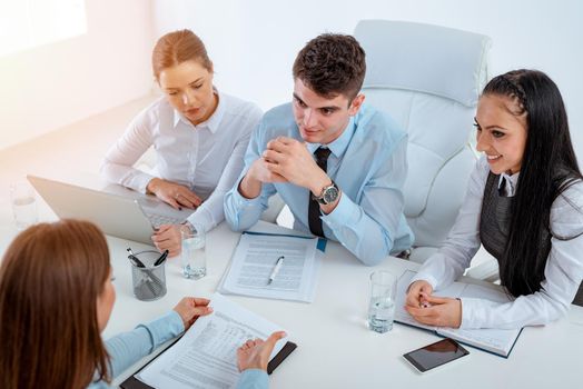 Top view on young businesswoman in front of the commission having a job interview.