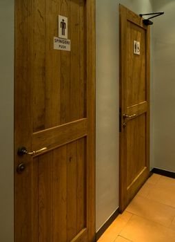 Wooden doors of male and female bathroom