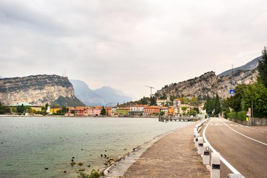 Beautiful lake Lago di Garda and the village of Torbole, Alpine scenery. Italy.