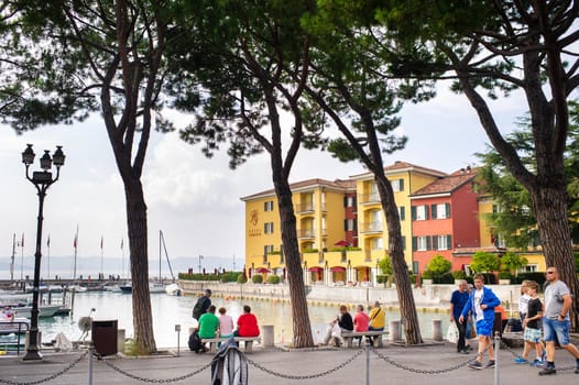 Sirmione, Italy-October 9, 2018: People relax in the town of Sirmione near the castle of Scaligera.