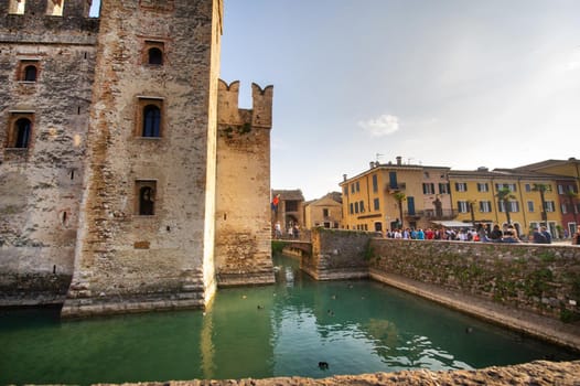 Sirmione, Italy-October 9, 2018: People relax in the town of Sirmione near the castle of Scaligera.