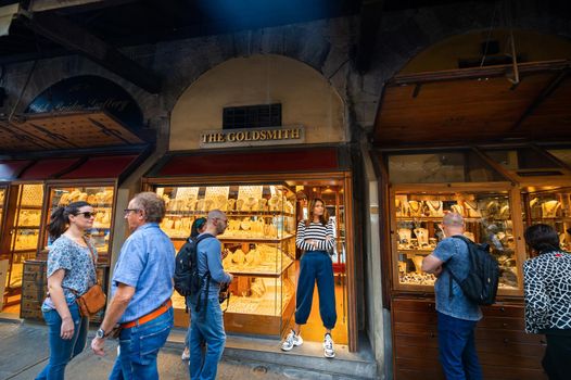 October 11, 2018.Tuscany.ITALY.FLORENCE: Jewelry store clerk and tourists on the Ponte Vecchio Bridge.