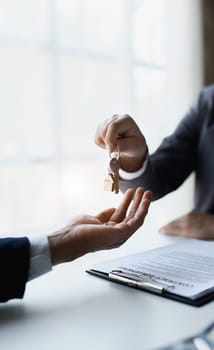 Real estate company to buy houses and land are delivering keys and houses to customers after agreeing to make a home purchase agreement and make a loan agreement