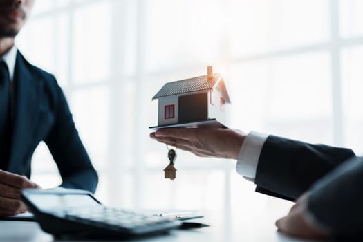 Real estate company to buy houses and land are delivering keys and houses to customers after agreeing to make a home purchase agreement and make a loan agreement