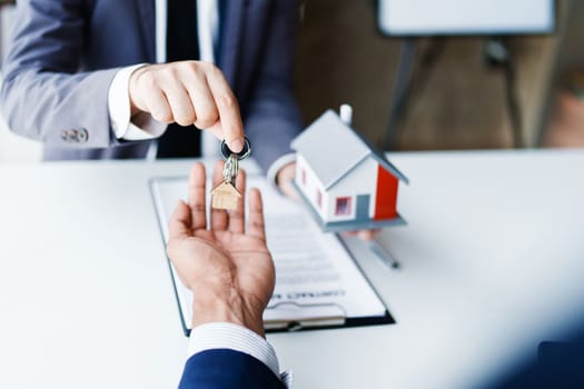 Real estate company to buy houses and land are delivering keys and houses to customers after agreeing to make a home purchase agreement and make a loan agreement