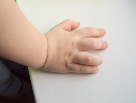 Child hand showing the five fingers isolated on a white background.