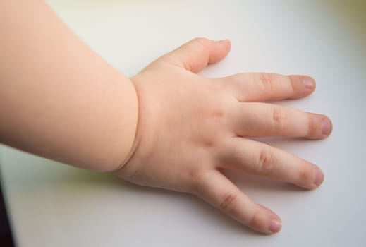 Child hand showing the five fingers isolated on a white background.