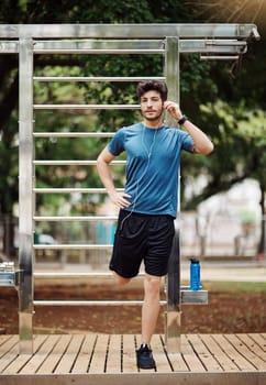 I do this every day. a sporty young man stretching his legs while exercising outdoors