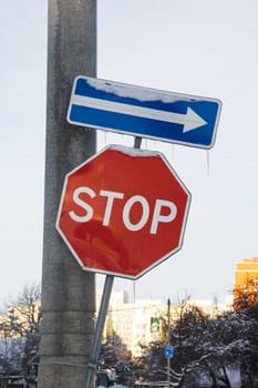 Road stop signs and post arrow close up