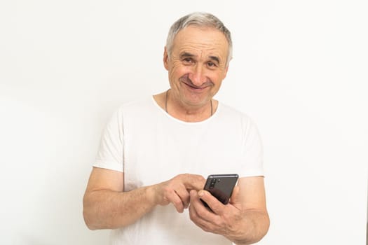 Happy retired man using a smartphone