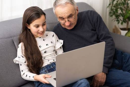grandfather and granddaughter with laptop.