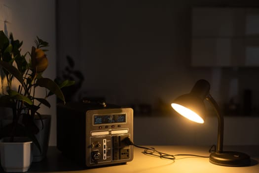 Portable power station charging gadgets on table in room