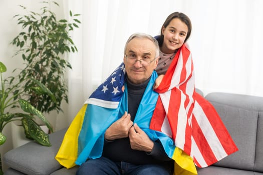 grandfather and granddaughter with the flags of the USA and Ukraine.