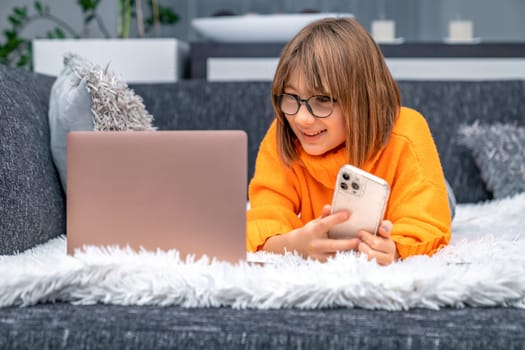 child rejoices success in front of laptop screen. High quality photo