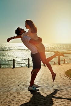 Love - sometimes a feeling, sometimes a verb. a happy young couple embracing on a summers day outdoors