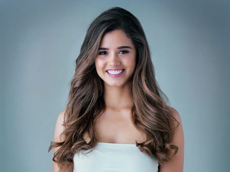 Shes an absolute stunner. Studio shot of a beautiful young woman posing against a gray background