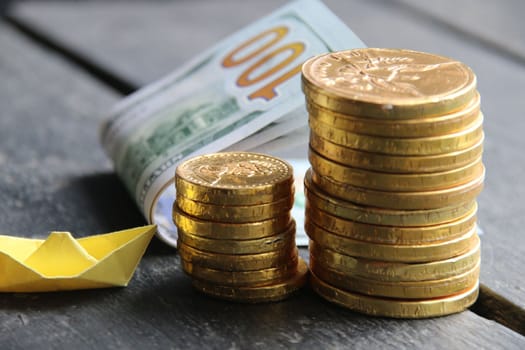 Business success, money, start up concept. Stack of golden coin on table background.