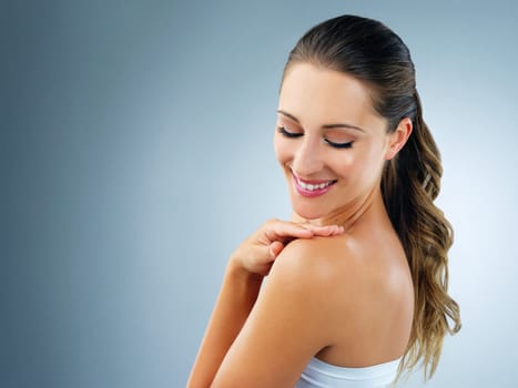 Flawless all over because she looks after her skin. Studio shot of a beautiful and healthy young woman against a blue background