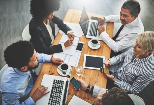 Theyll find a way with the help of wireless connections. a group of businesspeople having a meeting in an office