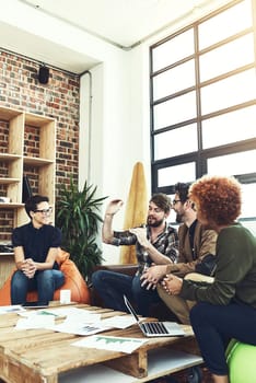 Be clear about what you want to grow. a group of young designers having a discussion in a modern office